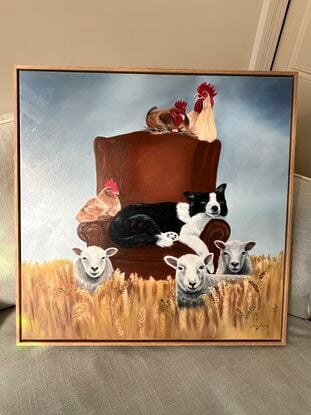 Old dog snoozing on a chair whilst farm animals party around it.  Wheat field, chair, chickens sheep, and dog. 