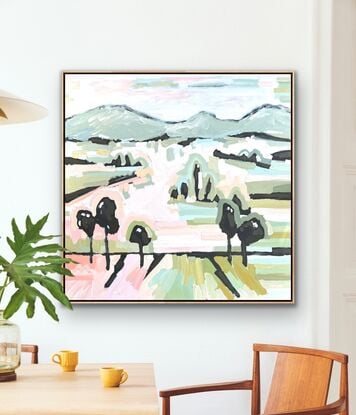 Large framed canvas with a textured landscape scene in pastel tones of orange, pinks, blues and greens. Abstract hills, trees and foliage shapes chunky paint with visible big brushstrokes.