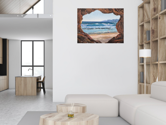 A view from a cave overlooking a pristine beach with a adult and child walking/playing to add some life.