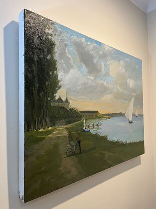 Shoreline at dusk with sailboats and a couple standing by the water