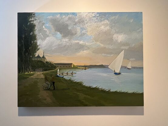 Shoreline at dusk with sailboats and a couple standing by the water