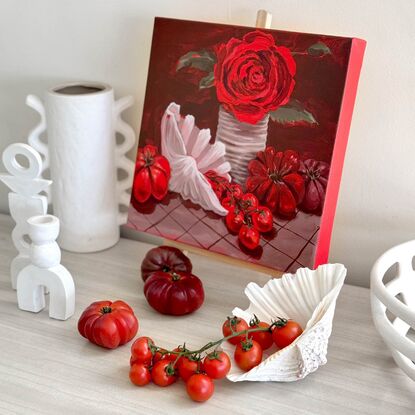 Juicy red tomatoes complimented with a gorgeous fragrant red rose. Cherry tomatoes spill out of a white clam shell. Heirloom tomatoes and a tin can complete the scene. The vibrant reds in the artwork and the bright red sides really make a statement.