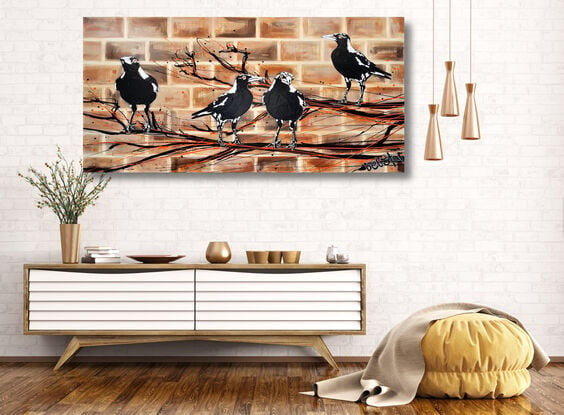 magpies sitting on a branch on brick wall