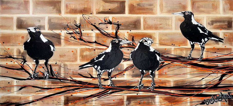 magpies sitting on a branch on brick wall