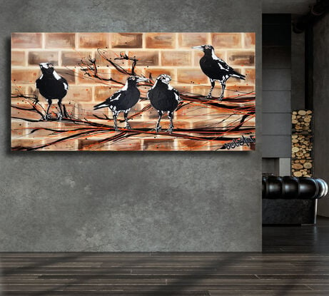 magpies sitting on a branch on brick wall