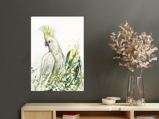 A mixed media painting of an Australian cockatoo in a wattle tree, by Sydney bird artist Leni Kae. The cockatoo sits with its crest up as a symbol of embracing the joy and happiness of the new season. 