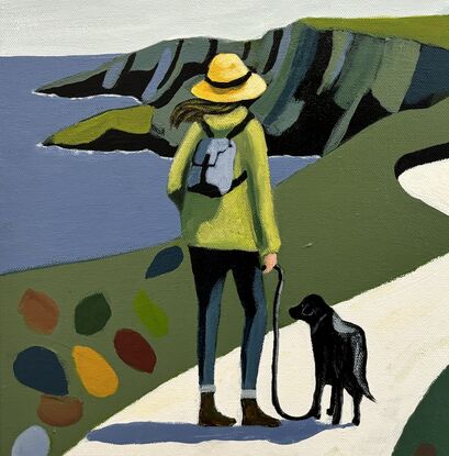 A lady wearing a green jacket, blue jeans and a yellow hat is walking her black dog along the coast along a winding white road or path that leads to a white Irish cottage. The lady had a brown long hair being blown to the side in the wind. The dog is on a leash. On the side of the white road there is green countryside with on the right a big black tree with branches with large coloured large oversized leaves. There are also some of these on the ground on each side of the path. The sky is overcast with some black birds flying. The coast has tall dark cliffs and the sea is a mud dark blue with white peaks of sea water where it meets the coastline. 