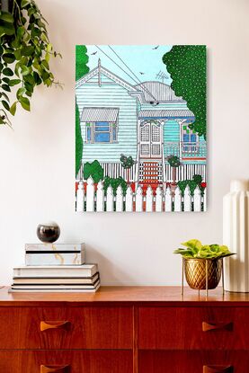 A colourful and vibrant depiction of the iconic Aussie low set Queenslander home. With coloured pink and green feature glass in the windows, a verandah to catch the breeze, a white picket fence and a tidy garden with pink and white speckles of flowers, this home radiates cool summer vibes. This artwork would make a beautiful addition to any home or office.