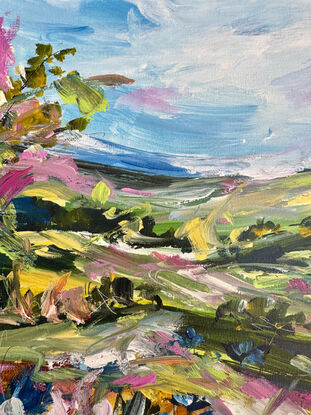 The abstract acrylic painting features a vibrant, chaotic landscape. Rolling hills undulate in bold, overlapping strokes of green, blue, and ochre, creating a sense of movement. In the distance, gum trees are suggested through erratic, vertical dashes of gray and green, their forms blending into the horizon. In the foreground, wildflowers burst forth in a riot of colors—pinks, purples, and yellows—applied with thick, textured brushstrokes. The painting's overall effect is dynamic and energetic, with the colors and shapes swirling together to evoke a lively, untamed natural scene.