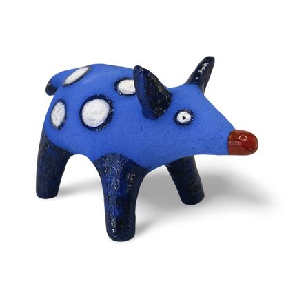 The Spotted Wombat features a playful, abstract rendition of a wombat, glazed in a striking deep blue with contrasting white circular spots and a red snout.