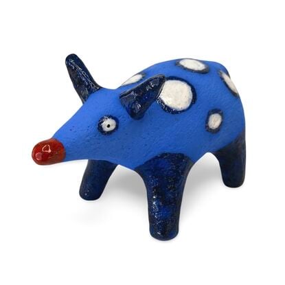 The Spotted Wombat features a playful, abstract rendition of a wombat, glazed in a striking deep blue with contrasting white circular spots and a red snout.