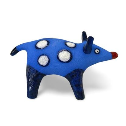 The Spotted Wombat features a playful, abstract rendition of a wombat, glazed in a striking deep blue with contrasting white circular spots and a red snout.