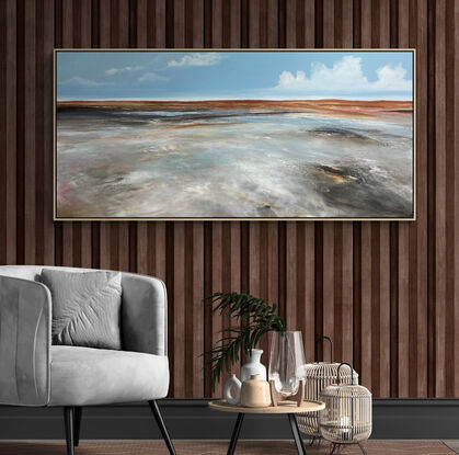 Neutral toned textured earthy abstract landscape with tan mountain range in the horizon, blue sky with clouds and mark making over the countryside.
