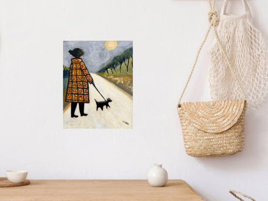 A naive style painting of a lady wearing a long ochre chequered patterned coat. She is walking a black dog on a lead along a long winding white path. There is foliage and skinny black trees on each side of the path and the sky is grey with a very pale ochre sun.