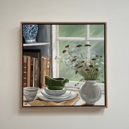 old books and flowers in window