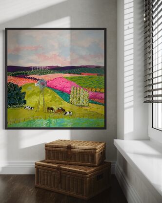 Cows grazing in brightly coloured pastures under a windmill.