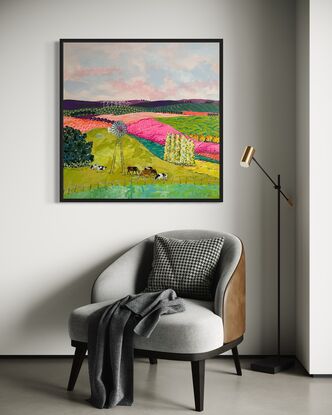 Cows grazing in brightly coloured pastures under a windmill.