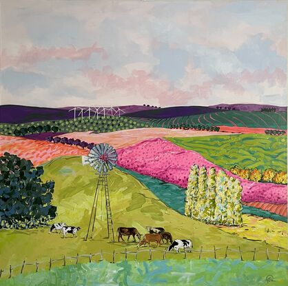 Cows grazing in brightly coloured pastures under a windmill.