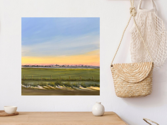 Sky dawn breaking through pink and yellow with trees in the background - grasses and a fence with foliage 