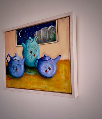 Three Quirky Teapots Against a pink wall and night sky cityscape