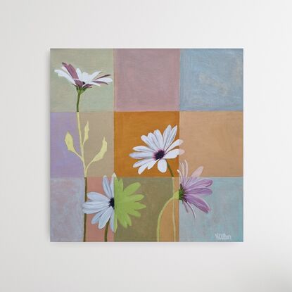 Four white daisies painted across a patchwork of 9 different colour squares in soft tones including pink, ochre, cream, blue and pale green. Where a flower crosses a square it changes from a realistic style to a block colour shadow.