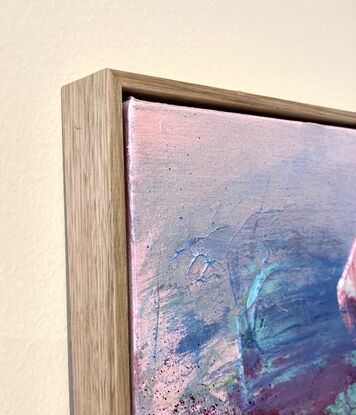 abstract painting framed in oak with pink and green