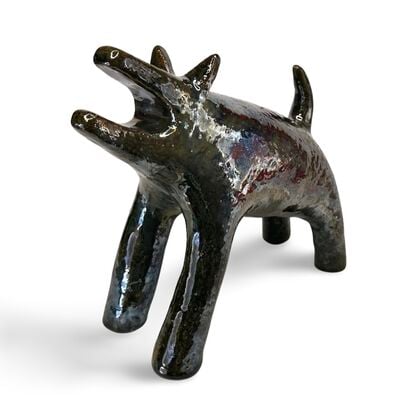 The "Raku Beast" is a striking ceramic sculpture with a glossy, dark Raku glaze that captures the untamed essence of a wild, howling creature. 
Freestanding, signed on back