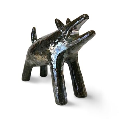 The "Raku Beast" is a striking ceramic sculpture with a glossy, dark Raku glaze that captures the untamed essence of a wild, howling creature. 
Freestanding, signed on back