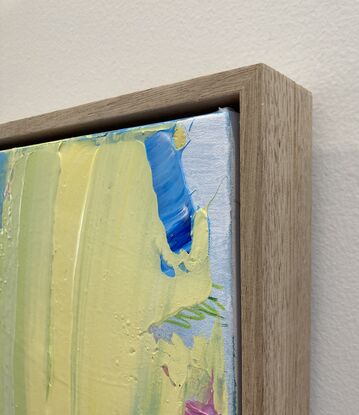 abstract painting framed in oak with pink and yellow