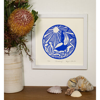 a linocut art print depicting a whale jumping out of water