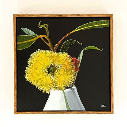 The painting features a bright yellow Eucalyptus Pressiana flower in full bloom, set against a dark background. Its vibrant stamens and green-grey leaves with bug marks are meticulously detailed. The flower rests in a simple white vase, creating a striking contrast with the moody backdrop.