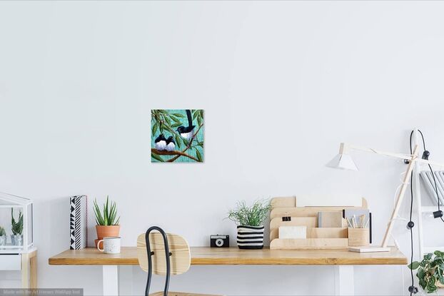 This painting is of a parent Willy Wagtail with two young chicks. The birds are black and white on a green background with branches and leaves hanging down.