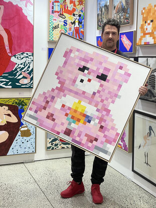 Pink/Purple pixelated teddy bear sitting on a white background