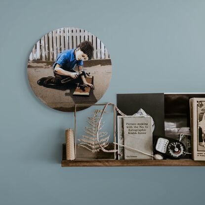 a boy repairs a wheel on his home made skateboard 