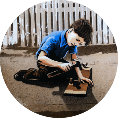 a boy repairs a wheel on his home made skateboard 