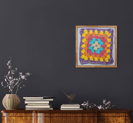 A crochet granny square with 6 rounds of pastel colours on a light grey background.