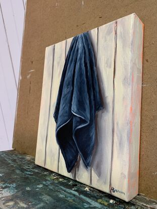 Blue tea towel hanging against panel wall  