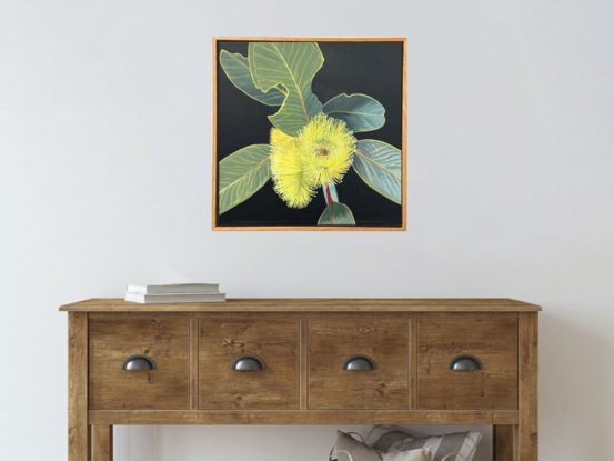 "Radiant Joy" features a bright yellow Eucalyptus Pressiana flower with green-grey leaves, celebrating the beauty of Australian flora and nature's imperfections.