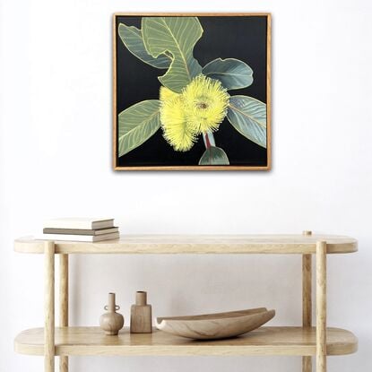 "Radiant Joy" features a bright yellow Eucalyptus Pressiana flower with green-grey leaves, celebrating the beauty of Australian flora and nature's imperfections.