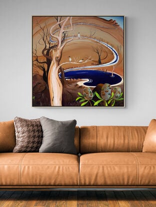 The Watering Hole by Tania Chanter is an abstract landscape painting, the canvas is bathed in warm caramel tones, creating an atmosphere of earthy richness and tranquility. A blue watering hole takes centre stage and trees and ibis birds randomly dot the landscape.