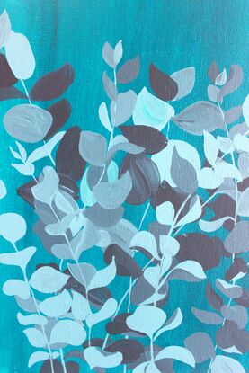 Dark and pale blue eucalyptus foliage on a gradient blue background