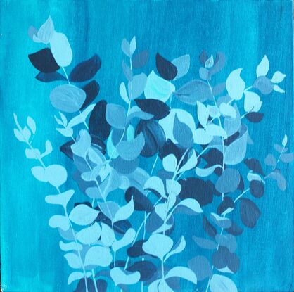 Dark and pale blue eucalyptus foliage on a gradient blue background