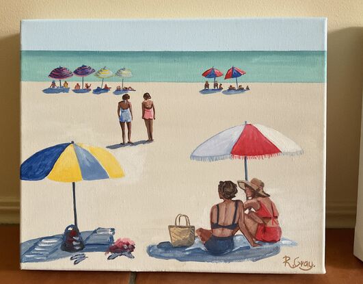 People sitting under beach umbrellas on the beach in the sixties. Ocean in background. 