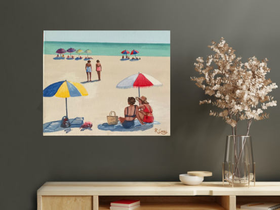 People sitting under beach umbrellas on the beach in the sixties. Ocean in background. 