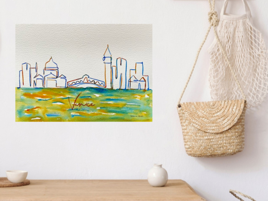 This minimalist watercolour artwork, titled "Venetian Skyline," captures the essence of Venice through a delicate and vibrant line drawing. The skyline features iconic landmarks such as the domes of St. Mark's Basilica and the bell tower of St. Mark’s Campanile, with the famous Rialto Bridge connecting the composition. Subtle, flowing strokes of green, blue, and yellow at the base evoke the surrounding waters, creating a serene and fluid atmosphere. The artist’s delicate use of colour and line work brings to life the historic beauty and charm of Venice in a contemporary, minimalist style.