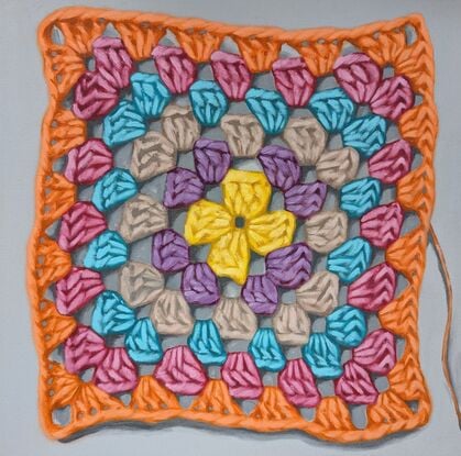 A crochet granny square with 6 rounds of bright colours on a light grey background.