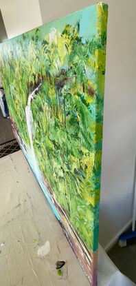 This painting depicts a stunning tropical landscape with a white titanium waterfall cascading down into crisp blue waters. The artist has utilized a variety of greens to create a lush and vibrant scenery, while textured paste adds depth and realism to the rocks below the waterfall. The large canvas size of 152 cm wide x 97 cm high allows viewers to immerse themselves in the serene beauty of this picturesque scene. The play of light and shadow enhances the natural beauty of the landscape, making it a captivating piece of art that evokes a sense of tranquility and awe.
Comes with a Certificate Of Authenticity and varnished to protect the life of the painting and boxed up for  safe delivery to your home 