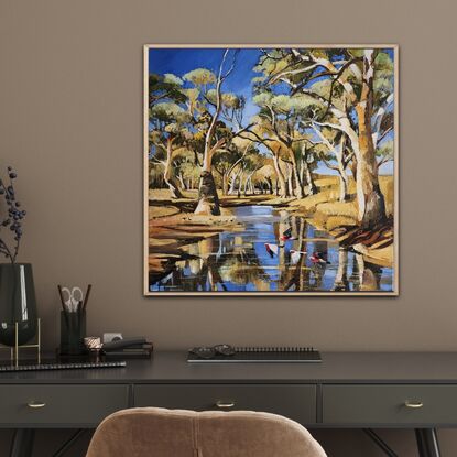 Australian gum trees along a riverbed with galahs.