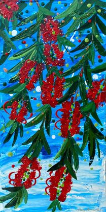 Close up of 10 bright red bottlebrush flowers hanging from a tree with a bright blue sky background. 