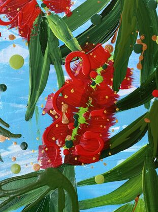 Close up of 9 bright red bottlebrush flowers hanging from a tree with a bright blue sky background. 